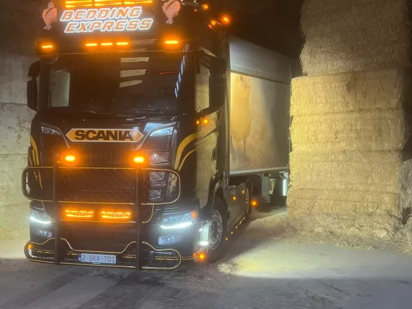 Vrachtwagen van Bedding Express bij strooisel in een loods
